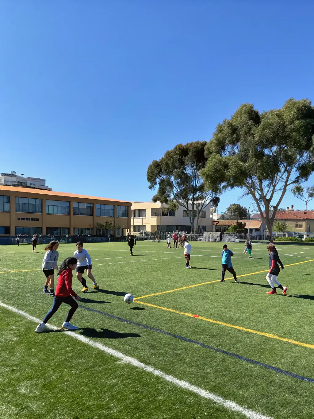 Students engaged in a soccer match, demonstrating teamwork, strategy, and physical fitness.